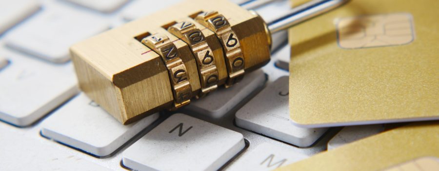 a golden padlock sitting on top of a keyboard