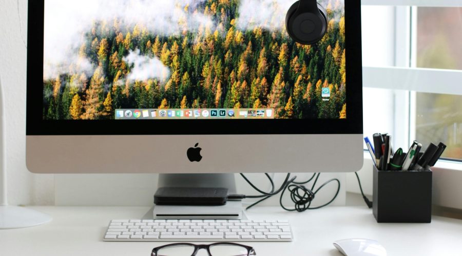 Free Stylish home office workspace featuring a computer setup with accessories. Stock Photo