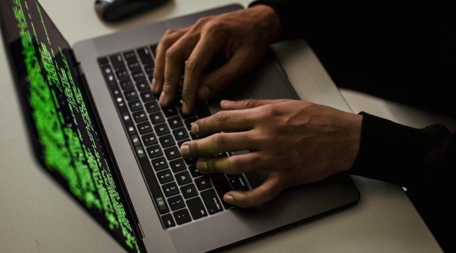 crop-cyber-spy-hacking-system-while-typing-on-laptop