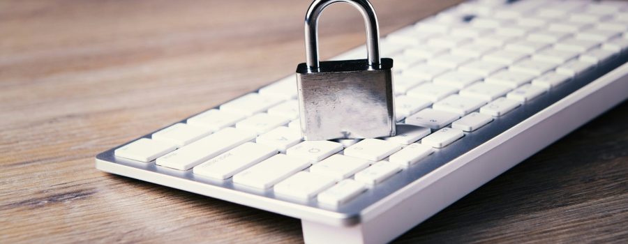 a computer keyboard with a padlock on top of it