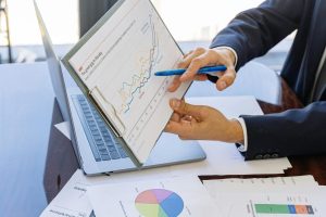 Free Business professionals discussing financial graphs and charts in an office setting. Stock Photo