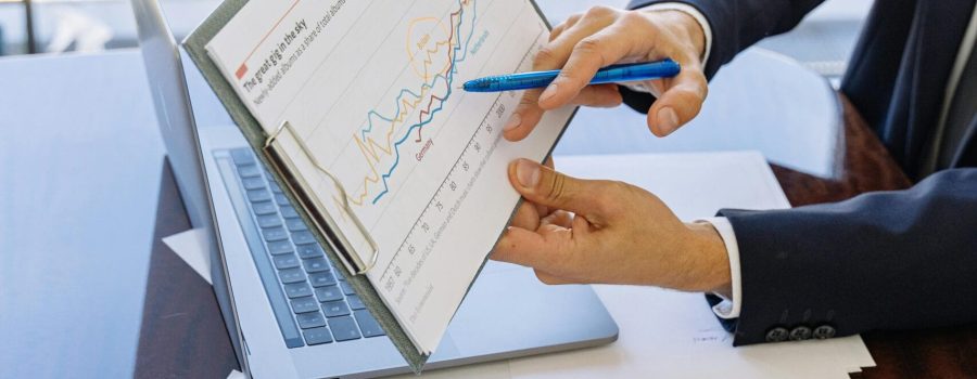 Free Business professionals discussing financial graphs and charts in an office setting. Stock Photo