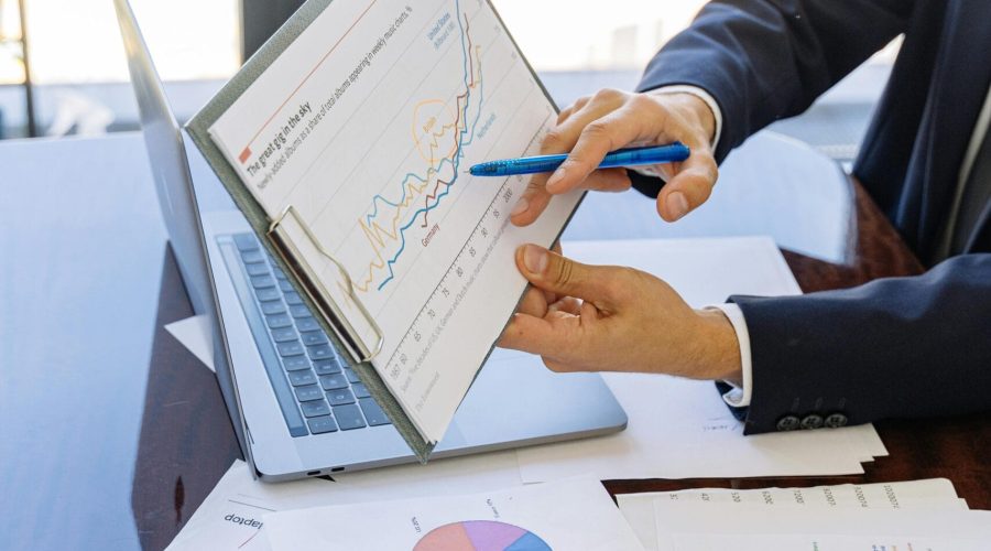 Free Business professionals discussing financial graphs and charts in an office setting. Stock Photo