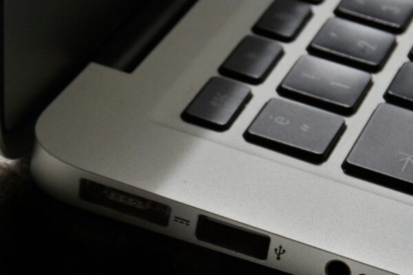 Free Detailed view of a silver laptop showing keyboard and multiple ports. Stock Photo