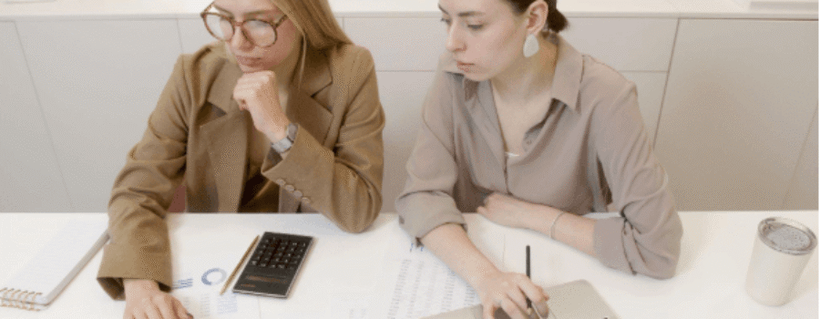 two women with laptops
